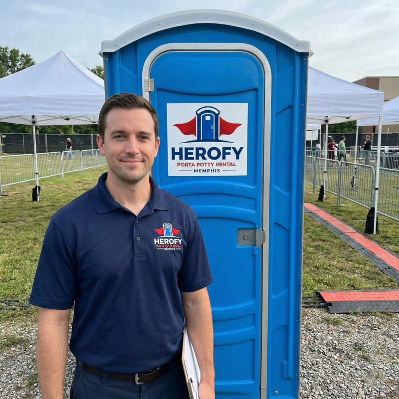 Employee at outdoor event with porta potty